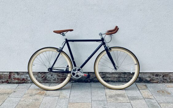 brown and white road bike on gray concrete floor